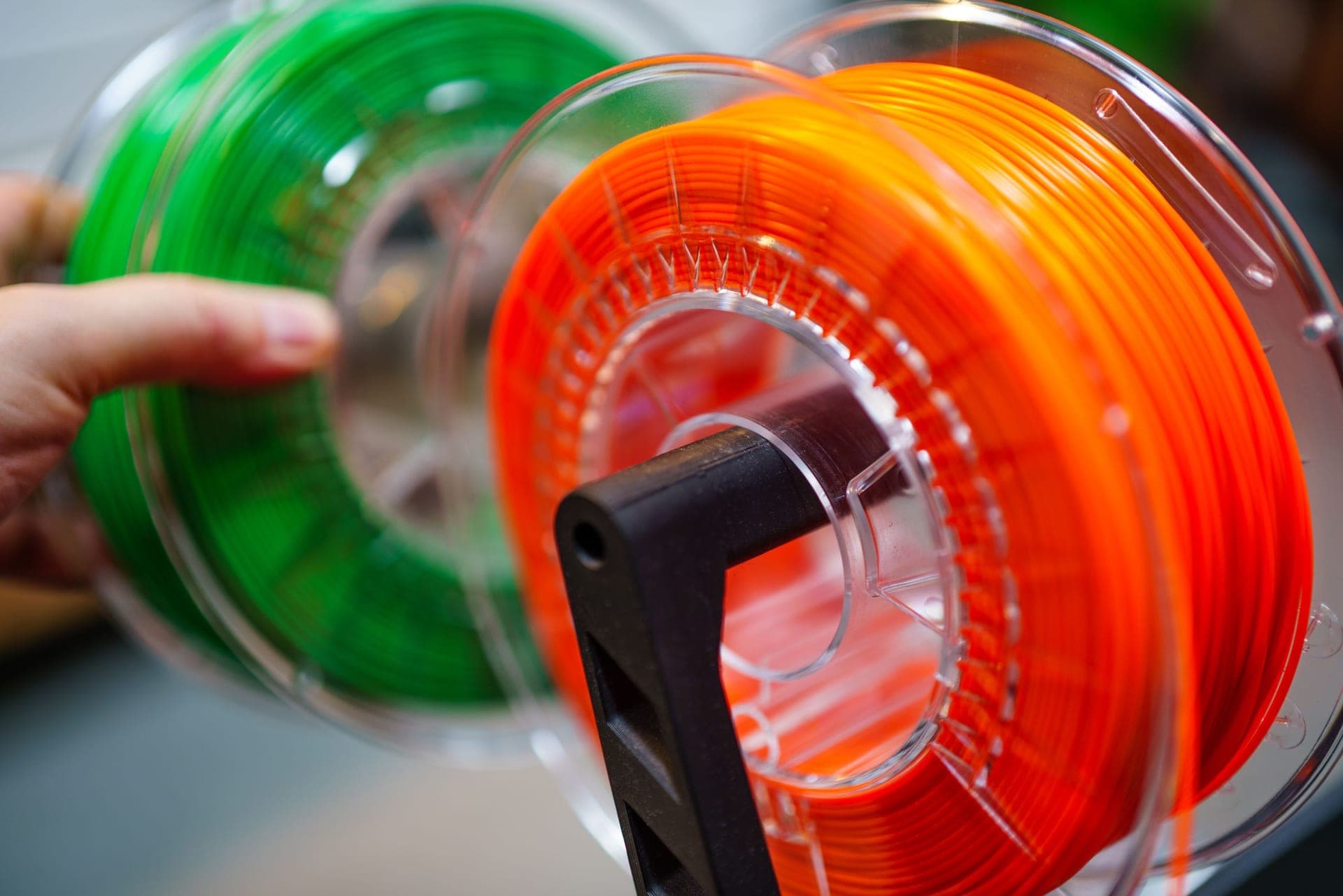 Several spools of PLA filament arranged on a workbench